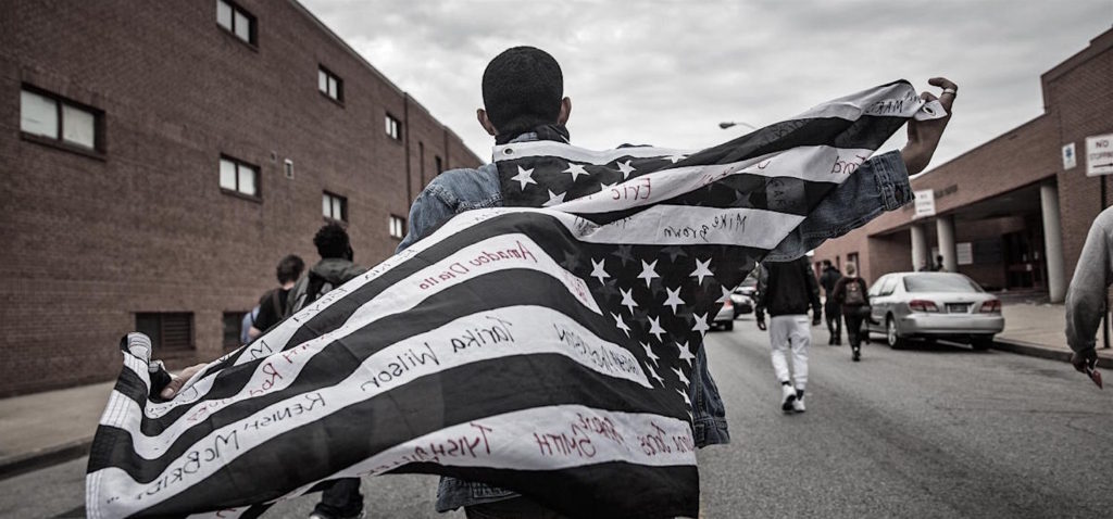 BALTIMORE, MD - MAY 01: Protesters march through the streets in support of Maryland state attorney Marilyn Mosby's announcement that charges would be filed against Baltimore police officers in the death of Freddie Gray on May 1, 2015 in Baltimore, Maryland. Gray died in police custody after being arrested on April 12, 2015. (Photo by Andrew Burton/Getty Images)