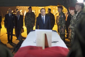 French President Hollande pays tribute near a flag-draped coffin bearing one of two French soldiers who was killed overnight, in Bangui